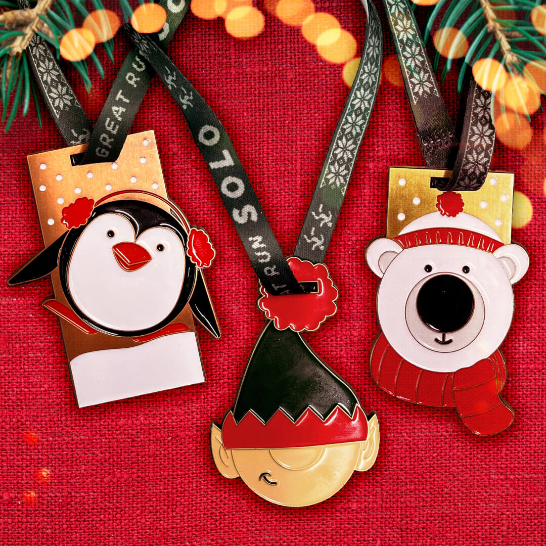 Image shows the three christmas medals, a penguing, elf and polar bear.