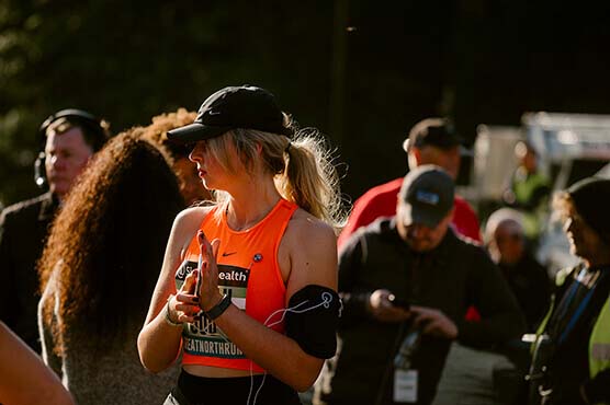 Runner with a mobile phone on the start line