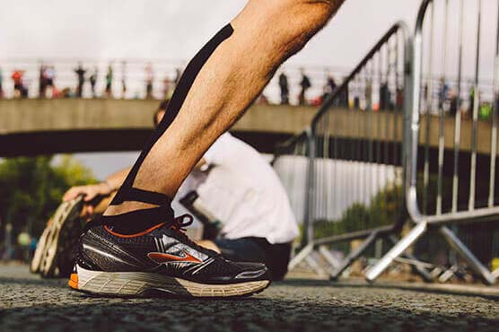 Leg of a runner stretching before an event